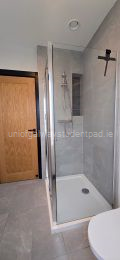 Enclosed shower in bathroom